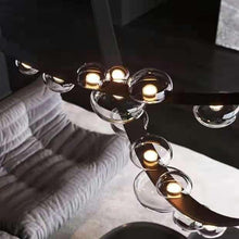 Load image into Gallery viewer, INSPIRA LIFESTYLES - Strapped Chandelier - ABSTRACT LIGHT, ACCENT LIGHT, BEDROOM LIGHT, BOARDROOM LIGHT, CHANDELIER, DINING LIGHT, FEATURE LIGHT, GLASS GLOBE CHANDELIER, GLOBE CHANDELIER, GLOBE LIGHT, HANGING LIGHT, HOTEL LIGHT, LEATHER STRAP LIGHT, LED CHANDELIER, LED LIGHT, LIGHT, LIGHT FIXTURE, LIGHTING, LIGHTS, LIVING ROOM LIGHT, MINIMAL LIGHT FIXTURE, MINIMALIST CHANDELIER, MINIMALIST LIGHT, MODERN CHANDELIER, MODERN LIGHT, MODERN PENDANT LIGHT, PENDANT LIGHT, RESTAURANT LIGHT, SCULPTURAL LIGHT