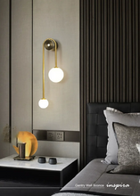 Load image into Gallery viewer, INSPIRA LIFESTYLES - Gentry Wall Sconce, postmodern dual globe wall light, frosted glass wall sconce, contemporary bedside wall lighting, sculptural architectural wall lamp, luxury modern wall light in brass finish
