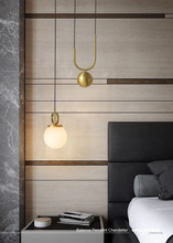 Load image into Gallery viewer, INSPIRA LIFESTYLES - Balance Pendant Chandelier, sculptural pendant light with frosted glass globe, modern bedside pendant lighting, gold and black minimalist hanging light for kitchen island, bathroom, and hospitality interiors

