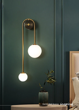 Load image into Gallery viewer, INSPIRA LIFESTYLES - Gentry Wall Sconce, postmodern dual globe wall light, frosted glass wall sconce, contemporary bedside wall lighting, sculptural architectural wall lamp, luxury modern wall light in brass finish
