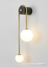 Load image into Gallery viewer, INSPIRA LIFESTYLES - Gentry Wall Sconce, postmodern dual globe wall light, frosted glass wall sconce, contemporary bedside wall lighting, sculptural architectural wall lamp, luxury modern wall light in brass finish

