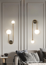 Load image into Gallery viewer, INSPIRA LIFESTYLES - Gentry Wall Sconce, postmodern dual globe wall light, frosted glass wall sconce, contemporary bedside wall lighting, sculptural architectural wall lamp, luxury modern wall light in brass finish
