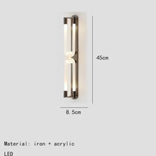 Load image into Gallery viewer, Inspira Lifestyles | Figaro Wall Sconce – Sculptural LED wall light with interlocking link design in brushed gold or matte black for modern and classic interiors
