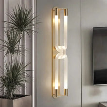 Load image into Gallery viewer, Inspira Lifestyles | Figaro Wall Sconce – Sculptural LED wall light with interlocking link design in brushed gold or matte black for modern and classic interiors
