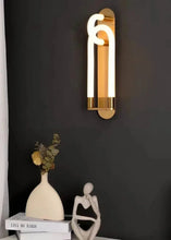 Load image into Gallery viewer, Inspira Lifestyles | Figaro Wall Sconce – Sculptural LED wall light with interlocking link design in brushed gold or matte black for modern and classic interiors
