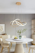 Load image into Gallery viewer, INSPIRA LIFESTYLES | Helia Twisted Pendant Light in chrome, polished gold, and matte black finishes, featuring a sculptural ribbon-like design, suspended with near-invisible wires to create a floating effect, perfect for modern interiors, dining rooms, stairwells, and contemporary living spaces, stylish lighting fixture, luxury pendant light, ambient illumination, contemporary ceiling lighting. Modern Chandelier, Minimalist Chandelier, Sculptural light, Dining table light, Living room light, LED Pendant
