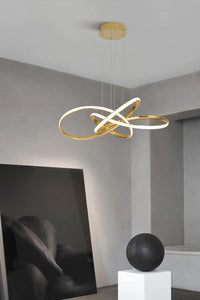 INSPIRA LIFESTYLES | Helia Twisted Pendant Light in chrome, polished gold, and matte black finishes, featuring a sculptural ribbon-like design, suspended with near-invisible wires to create a floating effect, perfect for modern interiors, dining rooms, stairwells, and contemporary living spaces, stylish lighting fixture, luxury pendant light, ambient illumination, contemporary ceiling lighting. Modern Chandelier, Minimalist Chandelier, Sculptural light, Dining table light, Living room light, LED Pendant