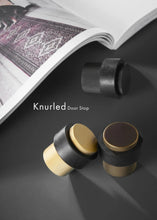 Load image into Gallery viewer, INSPIRA LIFESTYLES - Knurled Floor Door Stops featuring a crisscross diamond knurled pattern and protective rubber bumpers in Matte Black, Satin Brass and Antique Bronze.
