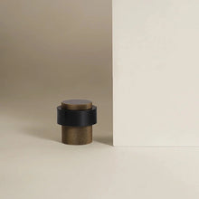 Load image into Gallery viewer, INSPIRA LIFESTYLES - Knurled Floor Door Stops featuring a crisscross diamond knurled pattern and protective rubber bumpers in Matte Black, Satin Brass and Antique Bronze.

