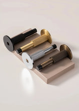 Load image into Gallery viewer, INSPIRA LIFESTYLES - Knurled Wall Door Stops with crisscross diamond-pattern detailing, adjustable length and rubber cushion pads in Matte Black, Satin Brass, Bright Chrome and Antique Bronze.
