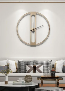 INSPIRA LIFESTYLES - Xavier Wall Clock, extra large wall clock, modern iron wall clock, sculptural wall decor, gold wall clock, charcoal wall clock, minimalist timepiece, statement wall accent, living room clock, office wall clock, oversized modern clock Modern wall clock on a white wall above a sofa with decorative pillows.