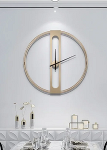 INSPIRA LIFESTYLES - Xavier Wall Clock, extra large wall clock, modern iron wall clock, sculptural wall decor, gold wall clock, charcoal wall clock, minimalist timepiece, statement wall accent, living room clock, office wall clock, oversized modern clock Modern wall clock on a white wall above a dining table with decorative items.