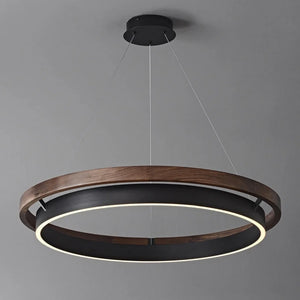 INSPIRA LIFESTYLES – Anello Duo Chandelier – sculptural two-tier chandelier with wood-patterned ring and matte black ring. Modern LED light fixture for dining rooms, living rooms, stairwells, offices, and transitional interiors.