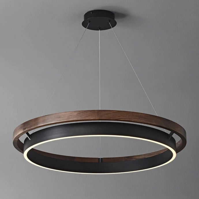 INSPIRA LIFESTYLES – Anello Duo Chandelier – sculptural two-tier chandelier with wood-patterned ring and matte black ring. Modern LED light fixture for dining rooms, living rooms, stairwells, offices, and transitional interiors.