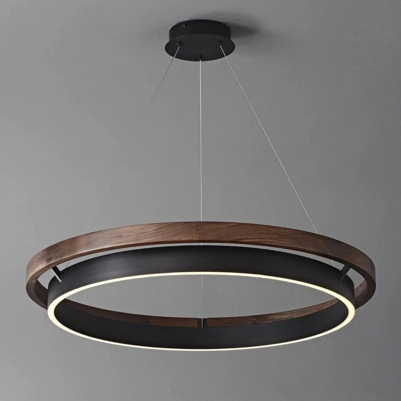 INSPIRA LIFESTYLES – Anello Duo Chandelier – sculptural two-tier chandelier with wood-patterned ring and matte black ring. Modern LED light fixture for dining rooms, living rooms, stairwells, offices, and transitional interiors.