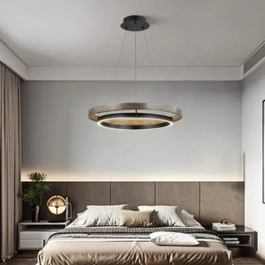INSPIRA LIFESTYLES – Anello Duo Chandelier – sculptural two-tier chandelier with wood-patterned ring and matte black ring. Modern LED light fixture for dining rooms, living rooms, stairwells, offices, and transitional interiors.