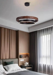 INSPIRA LIFESTYLES – Anello Duo Chandelier – sculptural two-tier chandelier with wood-patterned ring and matte black ring. Modern LED light fixture for dining rooms, living rooms, stairwells, offices, and transitional interiors.