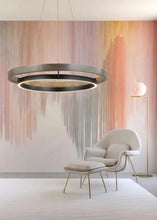 Load image into Gallery viewer, INSPIRA LIFESTYLES – Anello Duo Chandelier – sculptural two-tier chandelier with wood-patterned ring and matte black ring. Modern LED light fixture for dining rooms, living rooms, stairwells, offices, and transitional interiors.
