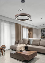 Load image into Gallery viewer, INSPIRA LIFESTYLES – Anello Duo Chandelier – sculptural two-tier chandelier with wood-patterned ring and matte black ring. Modern LED light fixture for dining rooms, living rooms, stairwells, offices, and transitional interiors.
