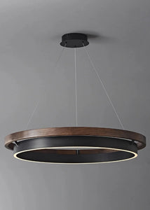 INSPIRA LIFESTYLES – Anello Duo Chandelier – sculptural two-tier chandelier with wood-patterned ring and matte black ring. Modern LED light fixture for dining rooms, living rooms, stairwells, offices, and transitional interiors.