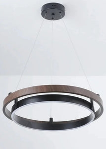 INSPIRA LIFESTYLES – Anello Duo Chandelier – sculptural two-tier chandelier with wood-patterned ring and matte black ring. Modern LED light fixture for dining rooms, living rooms, stairwells, offices, and transitional interiors.