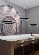 Load image into Gallery viewer, INSPIRA LIFESTYLES – Cuff Circular Pendant, modern ring chandelier in rose gold, gold, black, and white, minimalist circular LED pendant light for dining rooms, conference rooms, double-height spaces, and contemporary interiors
