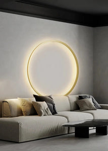 INSPIRA LIFESTYLES – Minimalist Metal Ring Light, a modern circular LED wall light with sleek sculptural design. This versatile wall sconce doubles as accent lighting and wall art, perfect as a bedroom light above a headboard, a living room statement piece, or a minimalist hallway fixture. Contemporary ring light crafted in metal with soft LED illumination, ideal for modern interiors seeking sculptural lighting, circle lights, or functional yet artistic wall sconces.