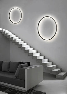 INSPIRA LIFESTYLES – Minimalist Metal Ring Light, a modern circular LED wall light with sleek sculptural design. This versatile wall sconce doubles as accent lighting and wall art, perfect as a bedroom light above a headboard, a living room statement piece, or a minimalist hallway fixture. Contemporary ring light crafted in metal with soft LED illumination, ideal for modern interiors seeking sculptural lighting, circle lights, or functional yet artistic wall sconces.