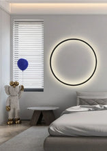 Load image into Gallery viewer, INSPIRA LIFESTYLES – Minimalist Metal Ring Light, a modern circular LED wall light with sleek sculptural design. This versatile wall sconce doubles as accent lighting and wall art, perfect as a bedroom light above a headboard, a living room statement piece, or a minimalist hallway fixture. Contemporary ring light crafted in metal with soft LED illumination, ideal for modern interiors seeking sculptural lighting, circle lights, or functional yet artistic wall sconces.
