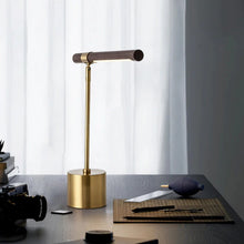 Load image into Gallery viewer, INSPIRA LIFESTYLES – Postaro Table Lamp – modern LED table lamp with postmodern design, featuring a dark wood base and satin brass accents. Sculptural yet functional lighting with a 90-degree adjustable tilt, perfect for bedside tables, home offices, and contemporary workspaces.
