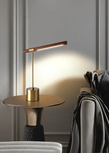 Load image into Gallery viewer, INSPIRA LIFESTYLES – Postaro Table Lamp – modern LED table lamp with postmodern design, featuring a dark wood base and satin brass accents. Sculptural yet functional lighting with a 90-degree adjustable tilt, perfect for bedside tables, home offices, and contemporary workspaces.

