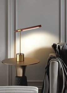 INSPIRA LIFESTYLES – Postaro Table Lamp – modern LED table lamp with postmodern design, featuring a dark wood base and satin brass accents. Sculptural yet functional lighting with a 90-degree adjustable tilt, perfect for bedside tables, home offices, and contemporary workspaces.
