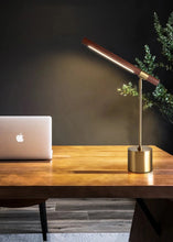 Load image into Gallery viewer, INSPIRA LIFESTYLES – Postaro Table Lamp – modern LED table lamp with postmodern design, featuring a dark wood base and satin brass accents. Sculptural yet functional lighting with a 90-degree adjustable tilt, perfect for bedside tables, home offices, and contemporary workspaces.
