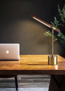 INSPIRA LIFESTYLES – Postaro Table Lamp – modern LED table lamp with postmodern design, featuring a dark wood base and satin brass accents. Sculptural yet functional lighting with a 90-degree adjustable tilt, perfect for bedside tables, home offices, and contemporary workspaces.