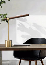 Load image into Gallery viewer, INSPIRA LIFESTYLES – Postaro Table Lamp – modern LED table lamp with postmodern design, featuring a dark wood base and satin brass accents. Sculptural yet functional lighting with a 90-degree adjustable tilt, perfect for bedside tables, home offices, and contemporary workspaces.
