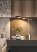 Load image into Gallery viewer, INSPIRA LIFESTYLES – Postaro Table Lamp – modern LED table lamp with postmodern design, featuring a dark wood base and satin brass accents. Sculptural yet functional lighting with a 90-degree adjustable tilt, perfect for bedside tables, home offices, and contemporary workspaces.
