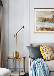 INSPIRA LIFESTYLES – Postaro Table Lamp – modern LED table lamp with postmodern design, featuring a dark wood base and satin brass accents. Sculptural yet functional lighting with a 90-degree adjustable tilt, perfect for bedside tables, home offices, and contemporary workspaces.