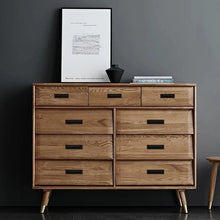 Load image into Gallery viewer, Inspira Lifestyles Lui Recessed Box Handles – Minimalist flush cabinet pulls, matte black and white hardware for sliding doors, drawers, closets, kitchen cabinetry, modern home hardware. Wooden dresser with multiple drawers against a dark gray wall.
