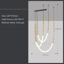 Load image into Gallery viewer, Siliq Sculptural Light with handcrafted silicone forms and metallic segmented cables, single minimalist pendant with glowing silicone tube, dramatic chandelier version of Siliq Light for high ceilings, floor-to-ceiling sculptural lighting installation in modern interior, flexible silicone light tubes emitting soft ambient glow, artistic designer light fixture styled in dining room, contemporary sculptural lighting as statement piece in commercial space.
