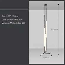 Load image into Gallery viewer, Siliq Sculptural Light with handcrafted silicone forms and metallic segmented cables, single minimalist pendant with glowing silicone tube, dramatic chandelier version of Siliq Light for high ceilings, floor-to-ceiling sculptural lighting installation in modern interior, flexible silicone light tubes emitting soft ambient glow, artistic designer light fixture styled in dining room, contemporary sculptural lighting as statement piece in commercial space.
