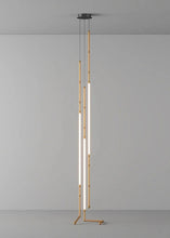 Load image into Gallery viewer, Siliq Sculptural Light with handcrafted silicone forms and metallic segmented cables, single minimalist pendant with glowing silicone tube, dramatic chandelier version of Siliq Light for high ceilings, floor-to-ceiling sculptural lighting installation in modern interior, flexible silicone light tubes emitting soft ambient glow, artistic designer light fixture styled in dining room, contemporary sculptural lighting as statement piece in commercial space.

