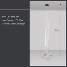 Load image into Gallery viewer, Siliq Sculptural Light with handcrafted silicone forms and metallic segmented cables, single minimalist pendant with glowing silicone tube, dramatic chandelier version of Siliq Light for high ceilings, floor-to-ceiling sculptural lighting installation in modern interior, flexible silicone light tubes emitting soft ambient glow, artistic designer light fixture styled in dining room, contemporary sculptural lighting as statement piece in commercial space.
