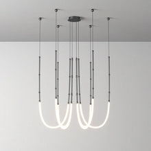 Load image into Gallery viewer, Siliq Sculptural Light with handcrafted silicone forms and metallic segmented cables, single minimalist pendant with glowing silicone tube, dramatic chandelier version of Siliq Light for high ceilings, floor-to-ceiling sculptural lighting installation in modern interior, flexible silicone light tubes emitting soft ambient glow, artistic designer light fixture styled in dining room, contemporary sculptural lighting as statement piece in commercial space.
