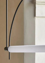Load image into Gallery viewer, Solari Arc Light with brass arc and linear LED tube, sculptural pendant available in gold or black finish, pair of Solari Arc Lights hanging in modern dining space, minimalist arc pendant styled in office interior, contemporary pendant lighting with sleek LED tube, statement arc light fixture for high ceiling interiors. Close-up of a white door handle on a door with a neutral background
