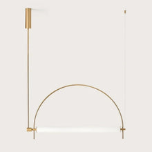 Load image into Gallery viewer, Solari Arc Light with brass arc and linear LED tube, sculptural pendant available in gold or black finish, pair of Solari Arc Lights hanging in modern dining space, minimalist arc pendant styled in office interior, contemporary pendant lighting with sleek LED tube, statement arc light fixture for high ceiling interiors. Gold arch-shaped wall light fixture on a white background
