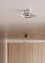 Load image into Gallery viewer, Inspira Lifestyles | Onda Crystal Wall Light with round optical crystal disc and chrome center, mounted as a modern LED wall or ceiling sconce.
