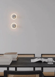 Inspira Lifestyles | Onda Crystal Wall Light with round optical crystal disc and chrome center, mounted as a modern LED wall or ceiling sconce.