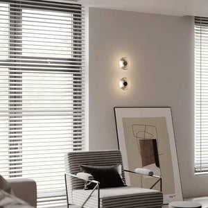 Inspira Lifestyles | Onda Crystal Wall Light with round optical crystal disc and chrome center, mounted as a modern LED wall or ceiling sconce.