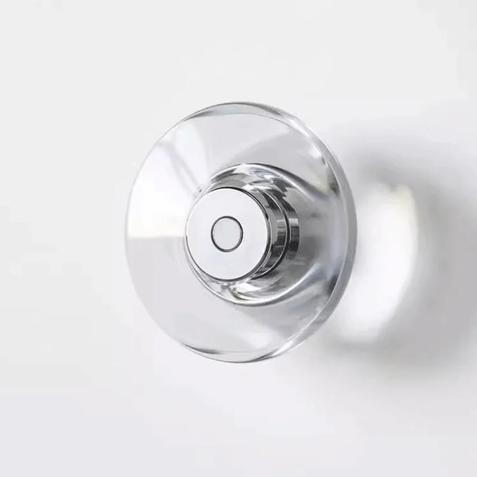 Inspira Lifestyles | Onda Crystal Wall Light with round optical crystal disc and chrome center, mounted as a modern LED wall or ceiling sconce.