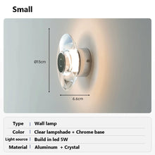 Load image into Gallery viewer, Inspira Lifestyles | Onda Crystal Wall Light with round optical crystal disc and chrome center, mounted as a modern LED wall or ceiling sconce.
